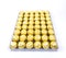 A lot of shiny golden chocolate wrapper in line on white background..