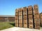 Lot of storage boxes with firewood in a factory at daytime