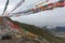 A lot of strings with colourful prayer flags on high pass near Lhasa, Tibet on a cloudy day