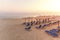 A lot of sunbed, straw umbrella on beautiful rising sun beach