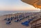 A lot of sunbed, straw umbrella on beautiful rising sun beach ba