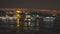 A lot of tourist ships and boats in Golden Horn with view to Suleymaniye Mosque on a nigtfall sky, Istanbul Turkey. 4K