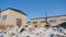 Lot of trash in abandoned factory. Stock footage. Pile of white trash on back of abandoned plant on blue sky background