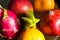 A lot of tropical fruits in a glass vase. Exotic fruits: averrhoa carambola, Pitahaya, Mango, tangerines, pomegranate fruit