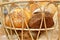 A lot variety breads in wicker basket on the table at commercial bakery kitchen