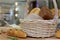 A lot variety breads in wicker basket on the table at commercial bakery kitchen