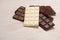 A lot of variety chocolates bar in box on white wooden background