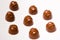 A lot of variety chocolates on white wooden background