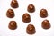 A lot of variety chocolates on white wooden background