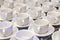 Lot of white porcelain tea pairs in piles in a straight line. Co