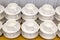 Lot of white porcelain tea pairs in piles in a straight line. Co