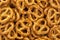 Lot of whole mini salted pretzels stack flatlay as abstract background.