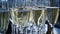 A lot of wine glasses with a cool delicious champagne or white wine at the bar. Alcohol background. Clip