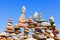 Lots of balanced, colorful stones against the blue sky