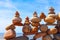 Lots of balanced, colorful stones on a beach on the background of the sea