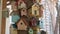 lots of beautiful multi-colored wooden decorative birdhouses on the tree.