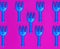 Lots of blue plastic baby rakes on pink background
