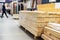 Lots of boards in a large package. Wholesale and retail trade in lumber in a specialized store. Selective focus
