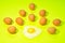 Lots of brown eggs with one fried egg in light green background