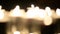 Lots of candles burning in the dark. Defocusing. White light, bokeh