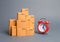 Lots of cardboard boxes and a red alarm clock. Express delivery concept. Optimization of logistics and delivery, improving