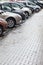 Lots of cars parking in city street on rainy day