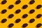 Lots of coffee beans stacked in rows. Seamless pattern in a minimalistic style on an orange background