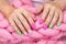 Lots of color gloss manicure hands has different blotches in pink background