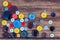 Lots of colorful buttons for clothes on wooden background.