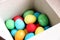 lots colorful eggs in a white box