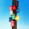 Lots of colorful wooden birdhouses on a tree against sky