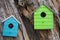 Lots of colorful wooden birdhouses on a tree against summer blue sky