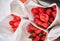 Lots of delicate bouquets of red tulips, top view. A selective focus of beautiful red tulips in a package.The concept of
