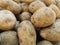 Lots of fresh brown potatoes on supermarket shelves