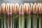 Lots of green and one brown cartridges for Kalashnikov assault rifle