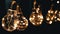 Lots Hanging Swinging Glowing Vintage Edison Light Bulbs on Black Background