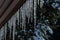 Lots of icicles frozen to a roof