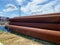 Lots of large diameter industrial iron rusty pipes with corrosion ready for installation plumbing for oil refinery petrochemical