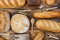 Lots of loaves of fresh bread and different ingredients. Bread and wheat, flour