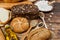 Lots of loaves of fresh bread and different ingredients. Bread and wheat, flour