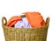 Lots of many clothes with in wicker basket on white background