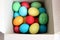 lots multicolored eggs in a white box