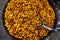 Lots of roasted cashews and almonds in a large bowl. Street food. Close-up