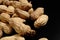 Lots of shelled peanuts on a black background. Closeup.