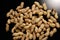 Lots of shelled peanuts on a black background. Closeup. The view from the top.