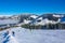 Lots of Skiers on a Wide and Gentle Ski Slope in Sunny Weather