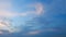 Lots of small clouds at sunset. Puffy fluffy cirrocumulus cloudscape slowly passed bright sun light rays. Timelapse.