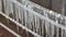 Lots of small, long, clean icicles hanging from a clothesline in cold winter weather