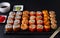 Lots of sushi , set of Japanese rolls  California with caviar,   Philadelphia with salmon,baked with cheese and eel, wasabi,
