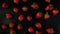 Lots of sweet, tasty and juicy garden strawberries, evenly distributed on a black background